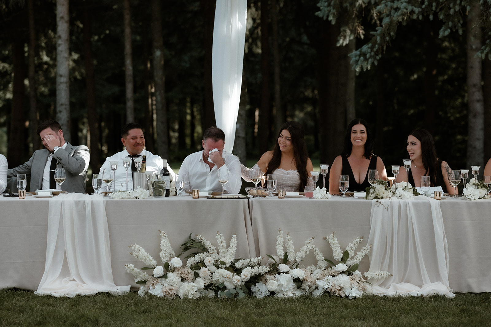 Wedding reception décor by Ellssi Events with natural linens, woven textures, and crisp white styling