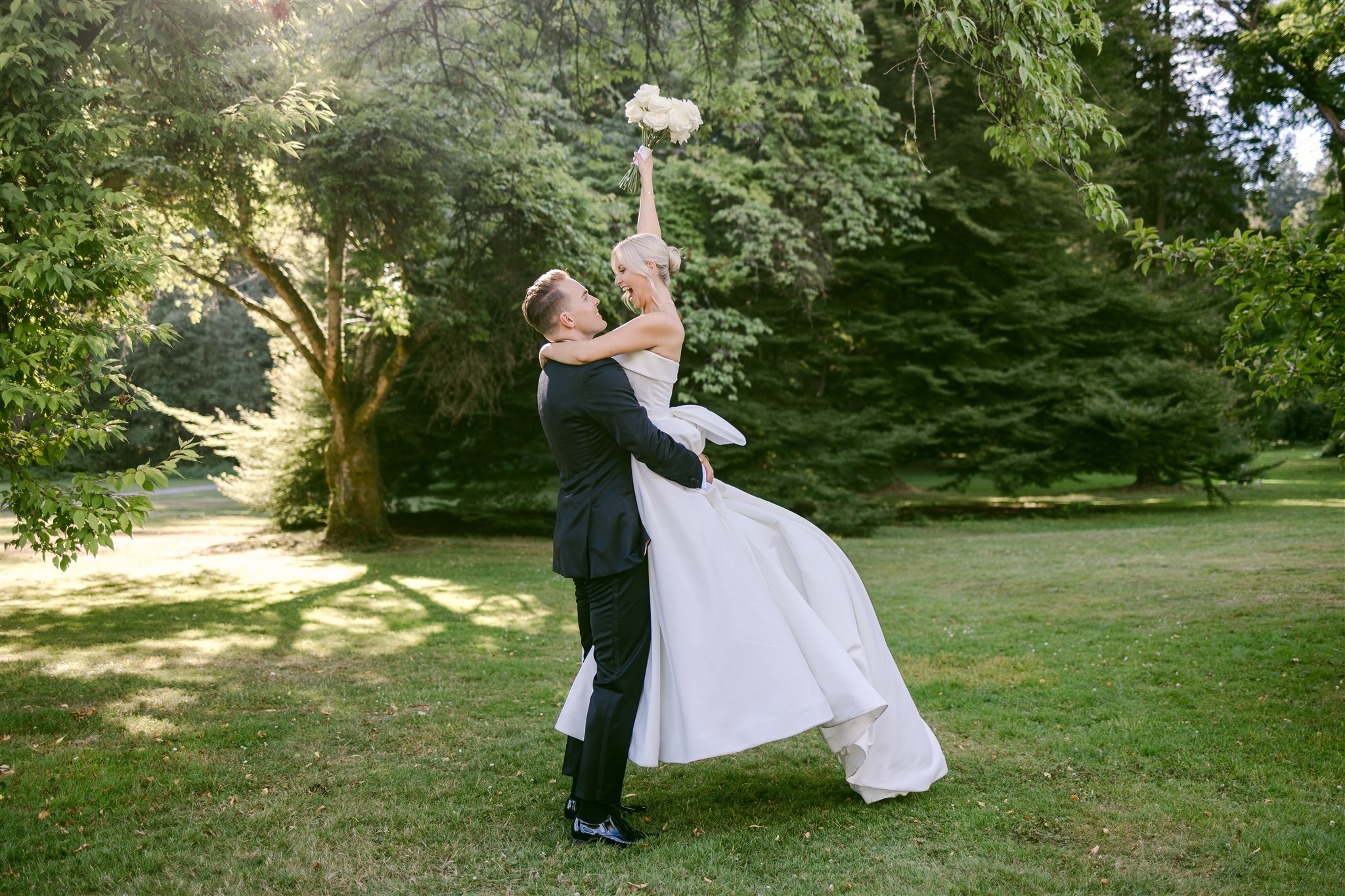 Bride and groom kissing in Stanley Park after their Vancouver wedding at Stanley Park Pavilion